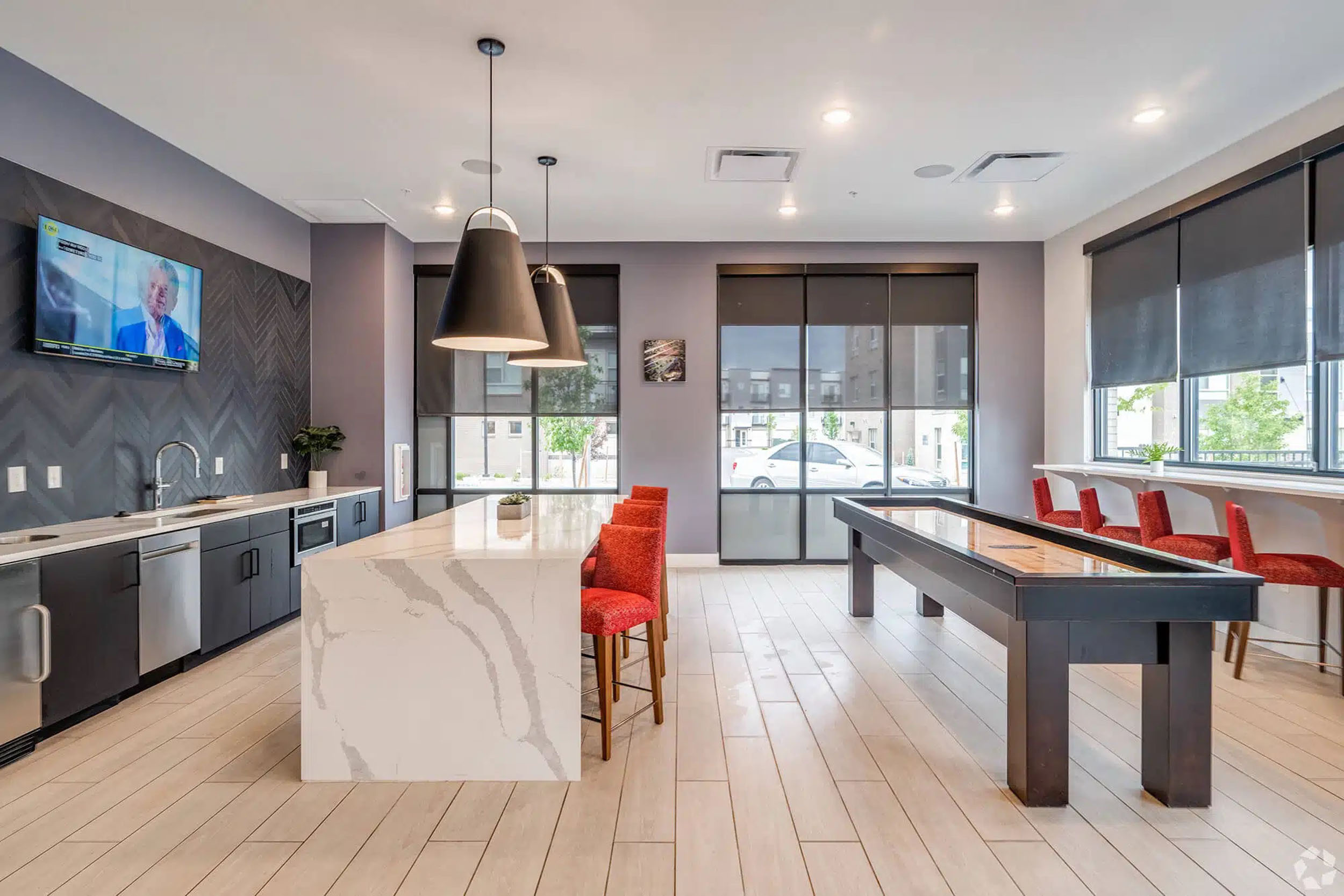 Clubhouse room with community kitchen and shuffleboard