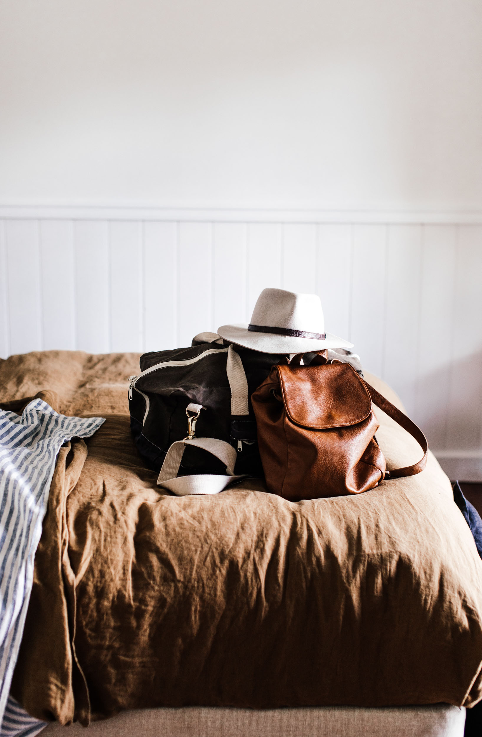 Travel bags packed on bed